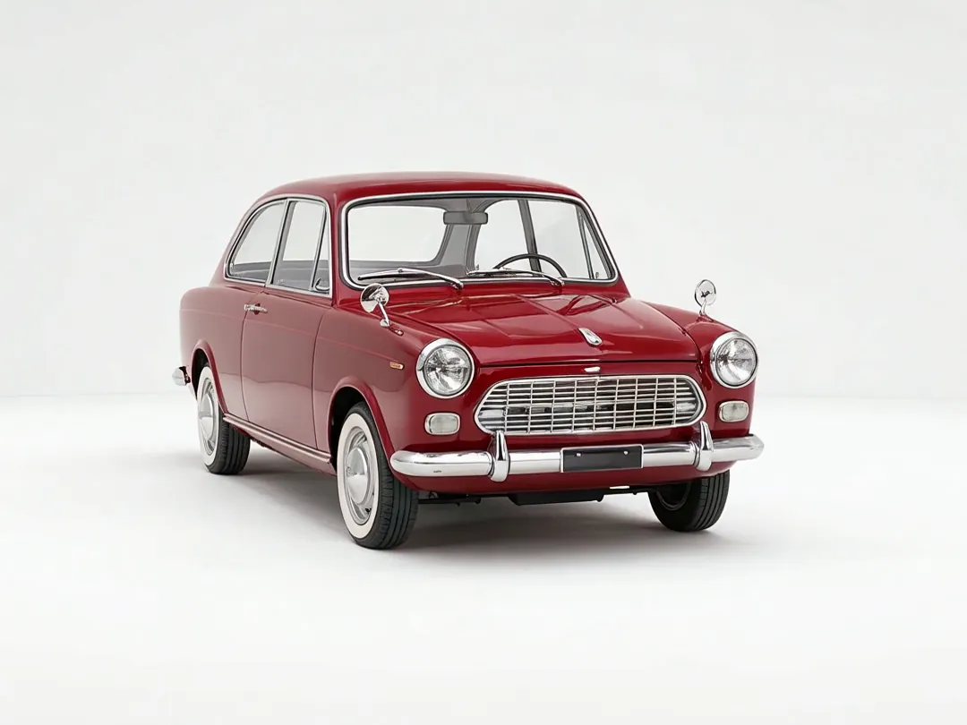 Front three-quarter view of the red saloon, chrome grille and round headlamps